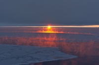 Sea smoke is illuminated by the setting sun. ©Winkelmann/Reese